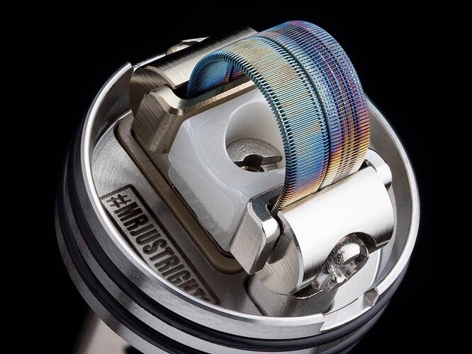 This image is a detailed close-up of the build of a vape atomizer with a colored heating wire. (AI-generated caption)