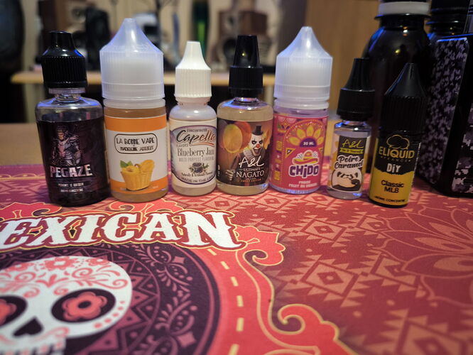 Several bottles of e-liquid with different flavors are visible on a Mexico-themed tablecloth. (Labeled by AI)