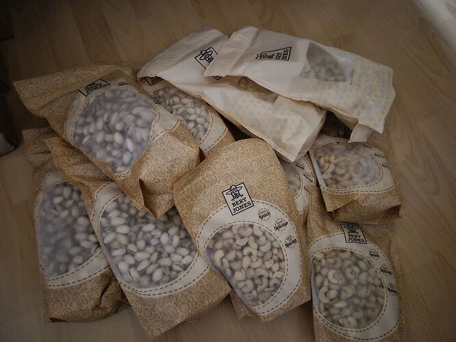 We can see several bags of mushrooms lying next to each other on the floor. (Labeled by AI)