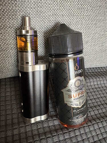 A vaper and a bottle of e-liquid are shown, labeled "SUPRA". (AI Captioned)