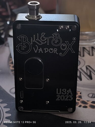 The black Bill Box Vapor box with a USB connector is visible on the table. (Labeled with AI)
