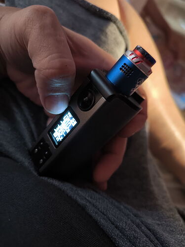 A hand holds an electronic cigarette with a lighter inserted into it. (Captioned by AI)