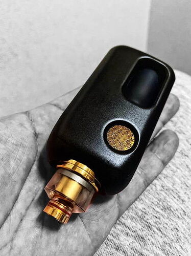 A modern, black electric cigarette or vape device with gold details held in a hand is visible in the picture. (Caption by AI)