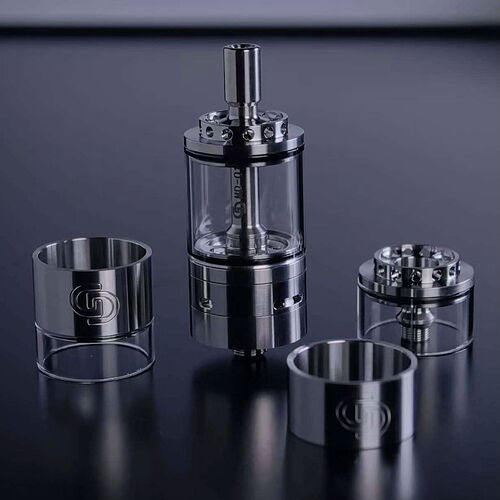 Assembled and disassembled stainless steel metal parts with transparent glass inserts are placed in various pieces on a dark surface. (Subtitled by AI)