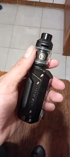 A hand holds a black Vape device, depicting a modern electronic cigarette. (Labeled by AI)