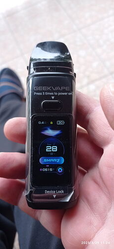 The image shows a Geekvape device, displaying power and current settings on its screen. (Labeled by AI)