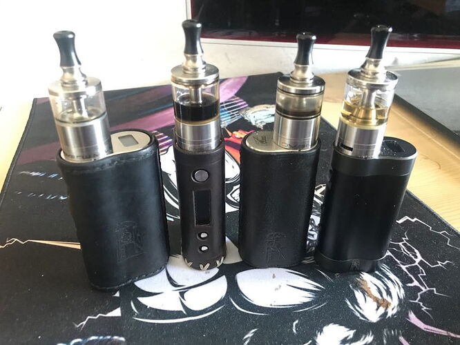 Four different vape devices are shown in the picture, placed on a rug. ( captioned by AI)