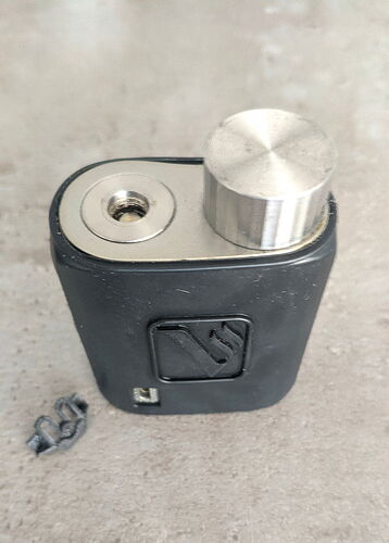 The image is a lock made of metal and plastic, with a rotating metal knob on top. (AI-generated caption)