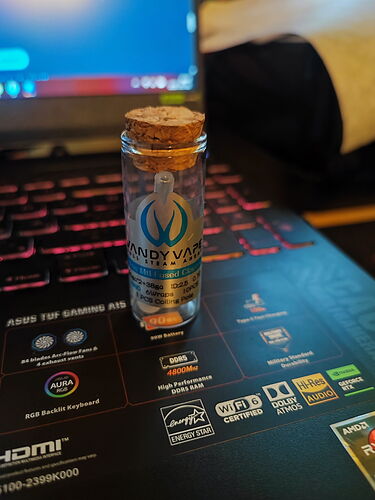 A small cork-stoppered bottle with the label "Candy Vape" on it, standing on a laptop keyboard. (AI-generated captions)
