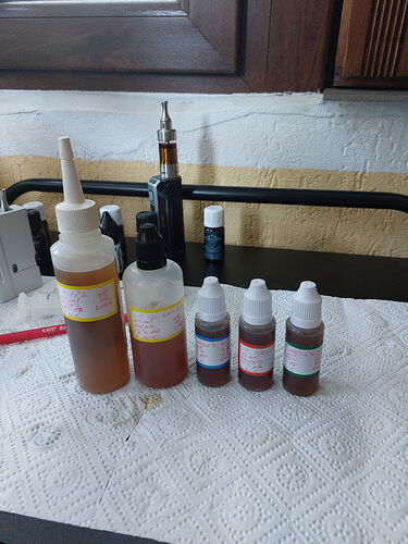 Plastic bottles and jars containing various liquids are lined up on the table under a paper towel. (Caption by AI)