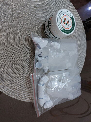 The image shows a jar and clear plastic bottles with caps on a round rug. (Captioned by AI)
