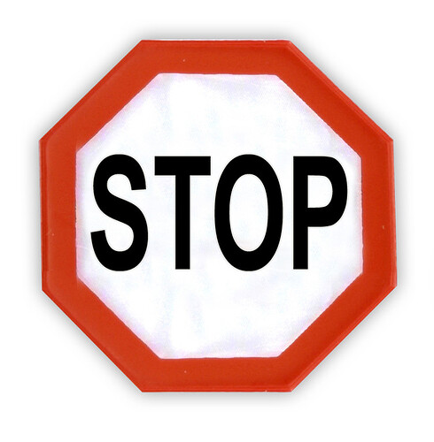 A white octagonal stop sign with a red border and a black "STOP" inscription is visible against a white background. (Labeled by AI)