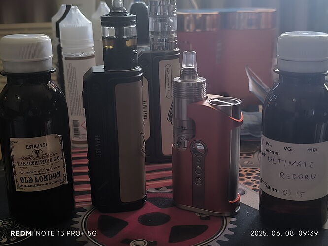 Several different e-cigarette devices and two dosing bottles are visible on the table. (Labeled by AI)