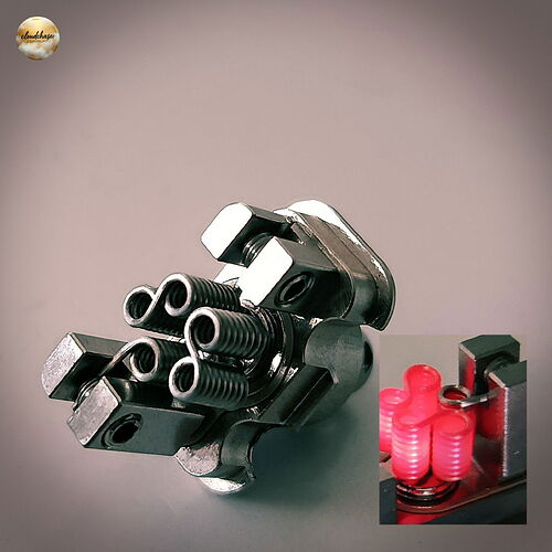 A képen egy fém vape tekercs látható, amelynek egy részlete kis képen pirosan izzik. (Feliratozva AI-val)