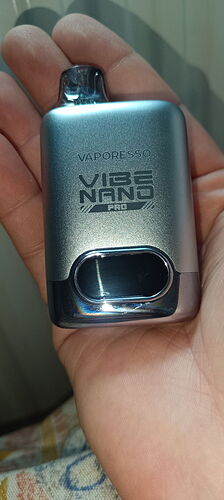 A silver Vaporesso Vibe Nano Pro e-cigarette held in a hand is shown in the [image]. (Labeled by AI)