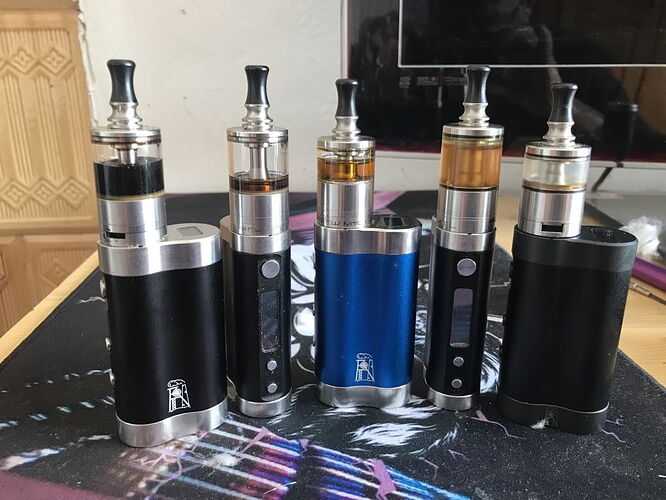 In the picture, five different vape devices are shown in different colors and shapes. (Labeled by AI)