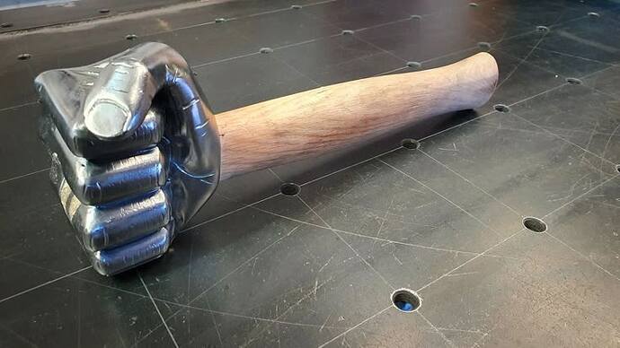 The image shows a baseball bat with a decoration shaped like a metal fist at its end. (Labeled by AI)