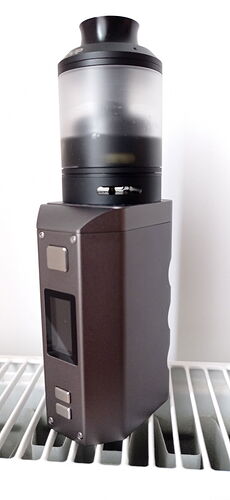 A brownish e-cigarette with a transparent tank on top. (Caption by AI)