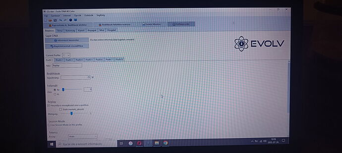 The image shows a laptop screen displaying the Evolv software user interface, with Hungarian menu items and settings. (Captioned by AI)