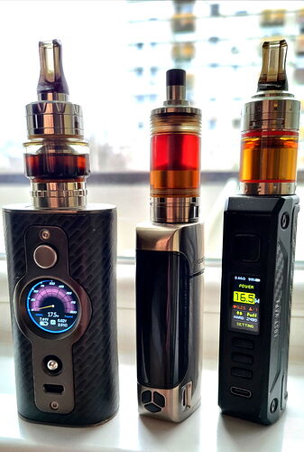 Three different vape devices are visible on the windowsill, with different colors and displays. (Labeled by AI)