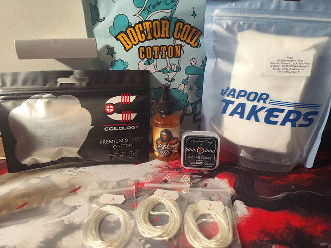 Various vaping supplies, such as cotton, e-liquid, and coils, are visible on a table. (AI-generated caption)