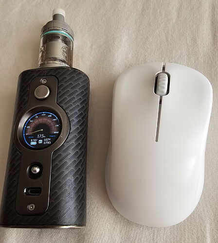 A black e-cigarette device and a white wireless mouse are visible next to each other in the picture. (Captioned by AI)