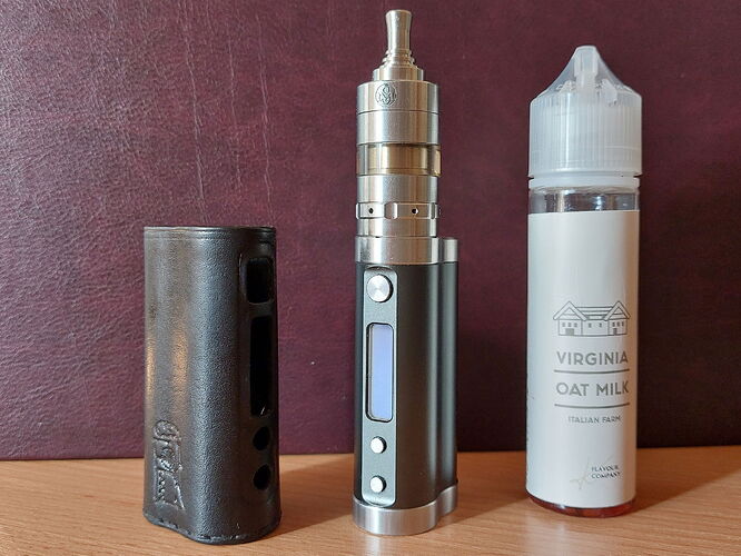 The image depicts a vape device, a bottle of flavored liquid, and a battery holder with a cover. (Captioned by AI)