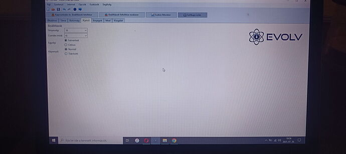 The image shows a laptop screen displaying the software interface with the 'EVOLV' logo, featuring setting options and menu items. (Captioned by AI)