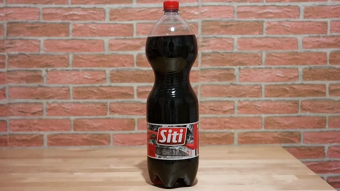 A 2-liter bottle of Siti cola-flavored soft drink is visible on the table. (Captioned by AI)