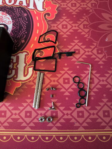 The image shows various parts, screws, and tools used for assembly. (Autogenerated by AI)