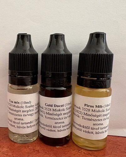 Three dropper bottles filled with liquids of different colors and contents stand next to each other in front of a plain background. (Captioned by AI)