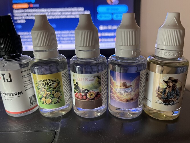 Five different e-liquid bottles are next to each other above a laptop keyboard, with different flavors and labels. (Labeled by AI)